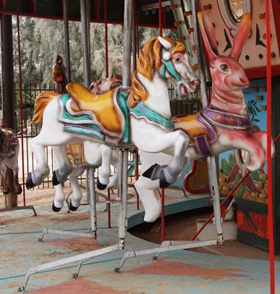 A picture containing carousel, outdoor object, ride, floor

Description automatically generated