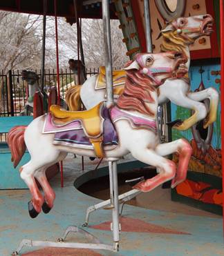 A picture containing carousel, ride, outdoor object, table

Description automatically generated