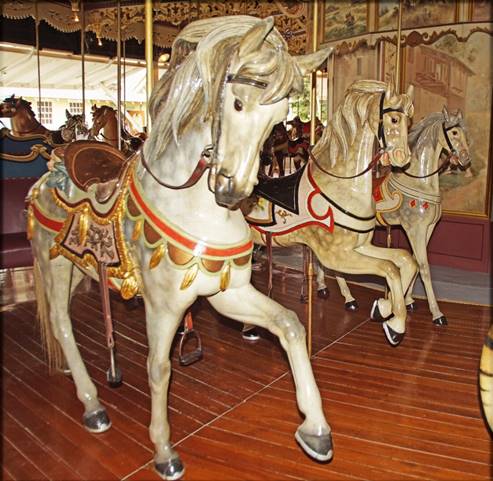 A picture containing floor, indoor, carousel, ride

Description automatically generated