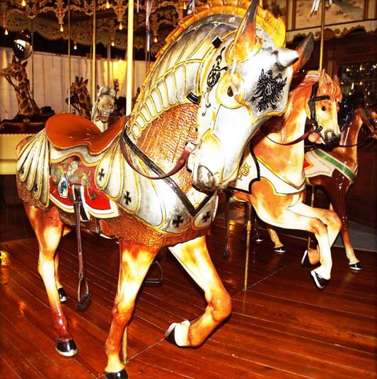 A picture containing floor, carousel, outdoor object, ride

Description automatically generated