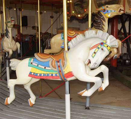 A picture containing carousel, outdoor object, floor, ride

Description automatically generated