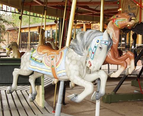 A group of horses in a merry-go-round

Description automatically generated with low confidence