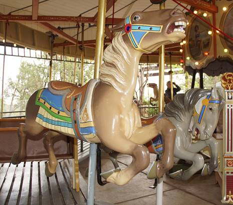 A couple of horses sit on a merry-go-round

Description automatically generated with low confidence