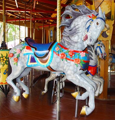 A picture containing carousel, indoor, ride, floor

Description automatically generated