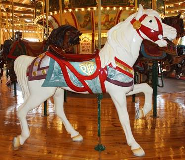 A horse statue in front of a carousel

Description generated with high confidence