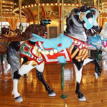 A person standing in front of a carousel

Description generated with high confidence
