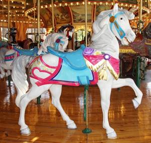 A horse standing on top of a carousel

Description generated with very high confidence