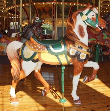 A person riding a horse in a carousel

Description generated with high confidence