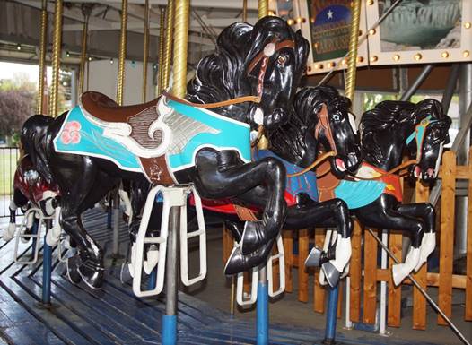 A picture containing indoor, carousel, outdoor object, ride

Description automatically generated