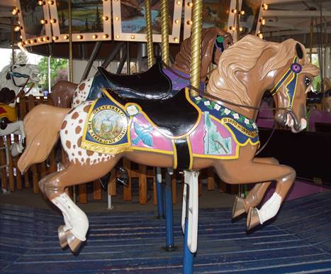 A picture containing carousel, outdoor object, floor, chair

Description automatically generated