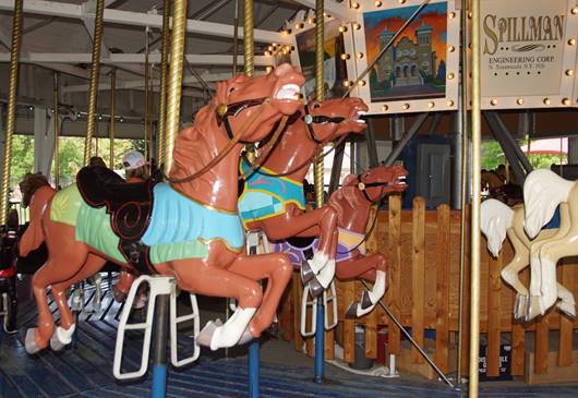 A picture containing carousel, outdoor object, ride, person

Description automatically generated
