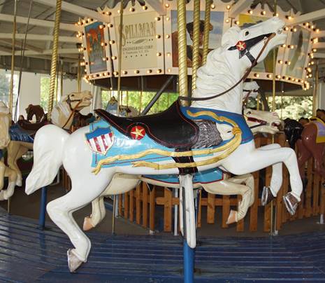 A picture containing text, floor, indoor, carousel

Description automatically generated