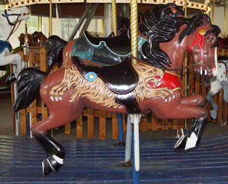 A picture containing carousel, outdoor object, ride, saddle

Description automatically generated