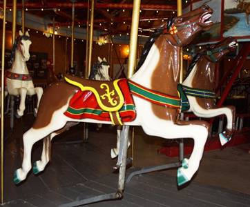 A chair sitting in front of a carousel

Description automatically generated