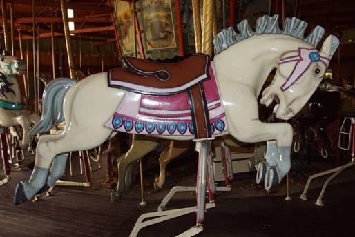 A chair sitting in front of a carousel

Description automatically generated