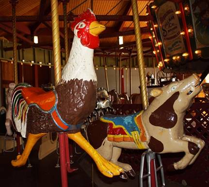 A picture containing carousel, ride, outdoor object, building

Description automatically generated