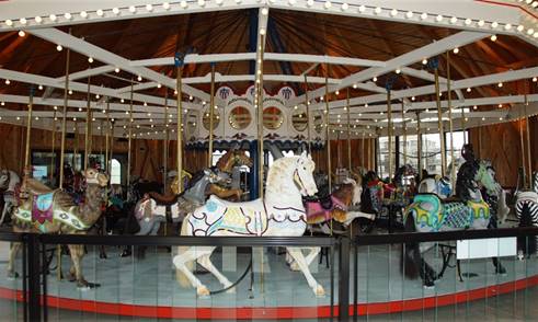 A carousel with horses and lights

Description automatically generated