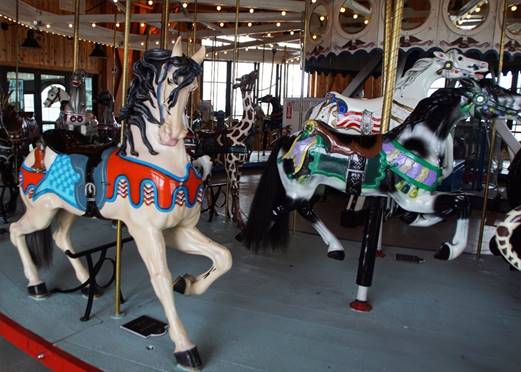 A carousel horses in a room

Description automatically generated with medium confidence