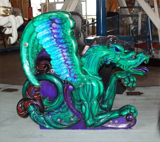 A green and blue dragon statue

Description automatically generated
