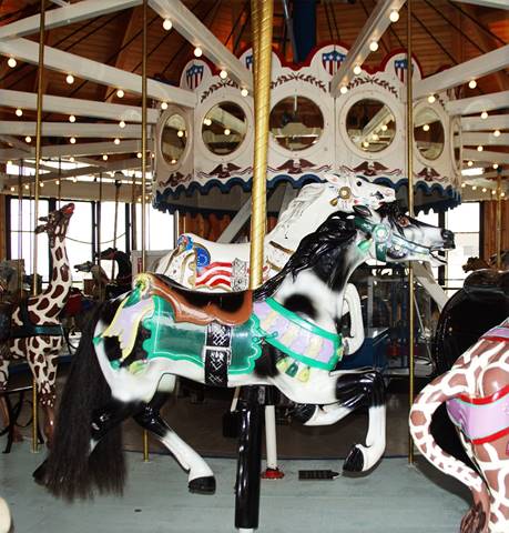 A carousel with horses and a carousel

Description automatically generated