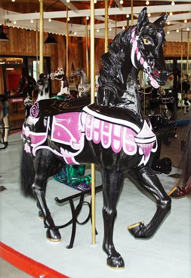 A black and pink carousel horse

Description automatically generated