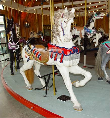 A carousel horse with horses on a carousel

Description automatically generated