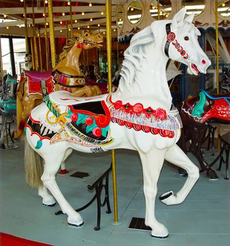 A white horse with red decorations

Description automatically generated