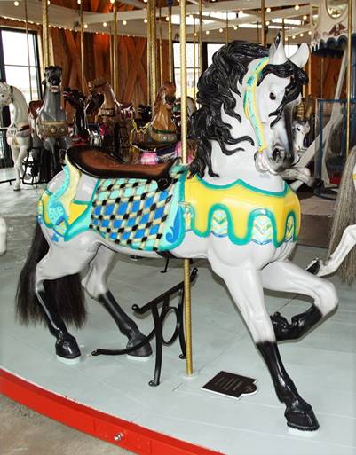 A carousel horse in a room

Description automatically generated