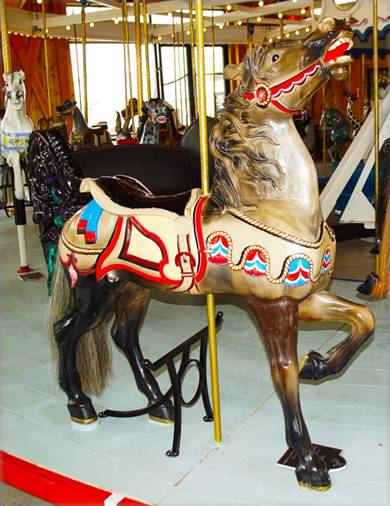 A carousel horse with a horse on it

Description automatically generated with medium confidence