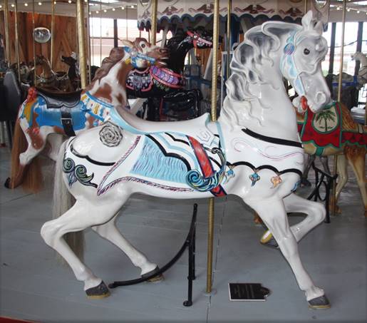 A white horse with a blue saddle

Description automatically generated with medium confidence