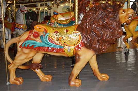 A picture containing carousel, ride, outdoor object, floor

Description automatically generated