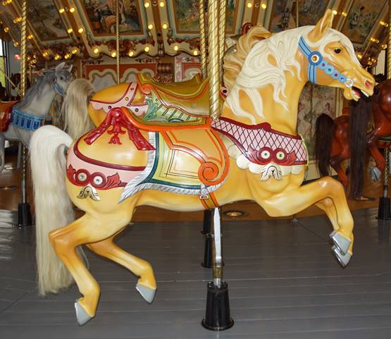 A picture containing carousel, ride, outdoor object, indoor

Description automatically generated