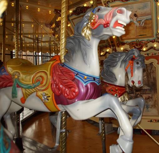 A group of people in a carousel

Description automatically generated