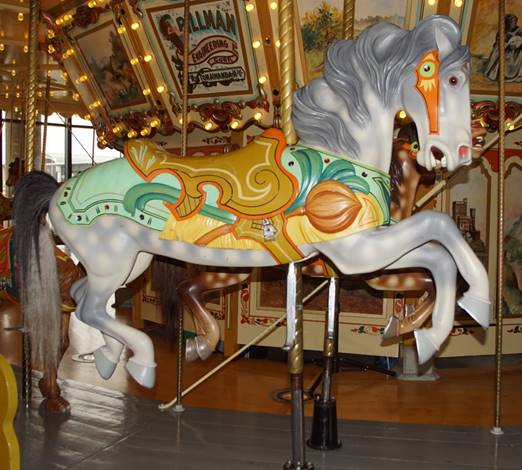 A picture containing carousel, ride, outdoor object, floor

Description automatically generated