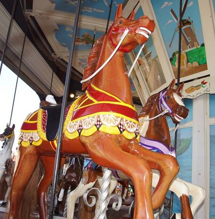 A picture containing building, indoor, carousel, floor

Description automatically generated