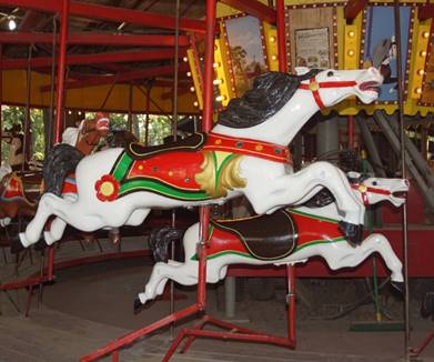 A large red chair in front of a carousel

Description generated with high confidence