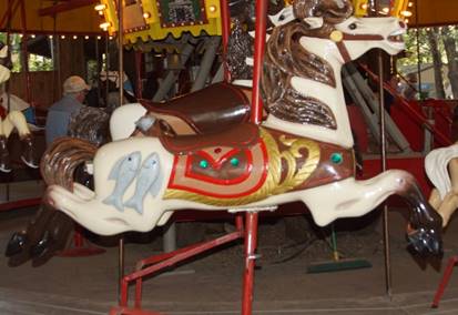 A chair sitting in front of a carousel

Description generated with high confidence