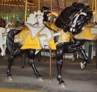 A picture containing floor, indoor, yellow, carousel

Description generated with high confidence