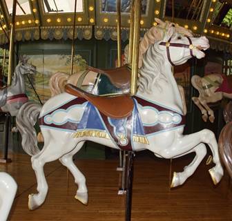 A person standing in front of a carousel

Description automatically generated