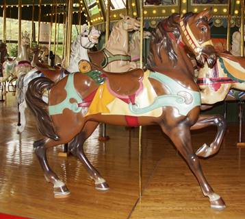 A picture containing carousel, outdoor object, floor, ride

Description automatically generated