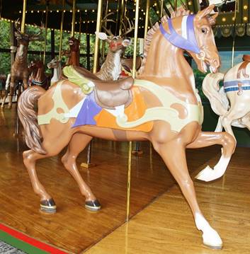 A person leaning on a carousel horse

Description automatically generated