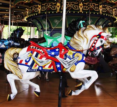 A picture containing carousel, ride, floor, outdoor object

Description automatically generated