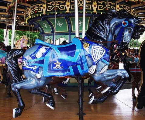 A picture containing floor, carousel, ride, blue

Description automatically generated