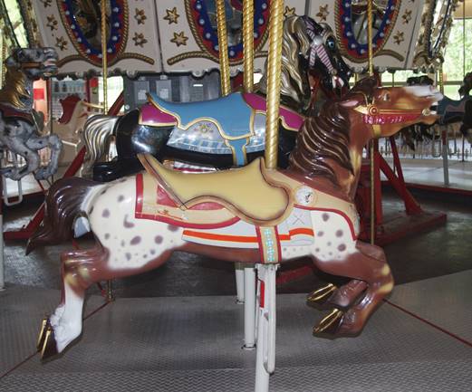 A merry go round with horses

Description automatically generated