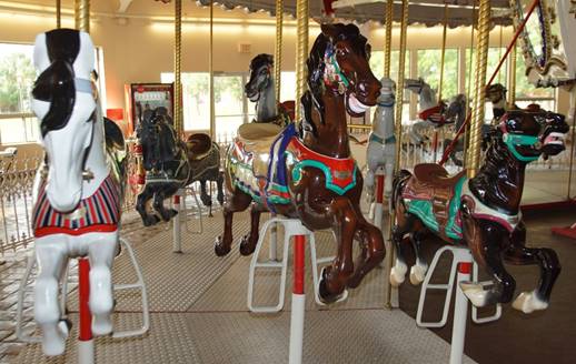 A group of horses on a merry go round

Description automatically generated