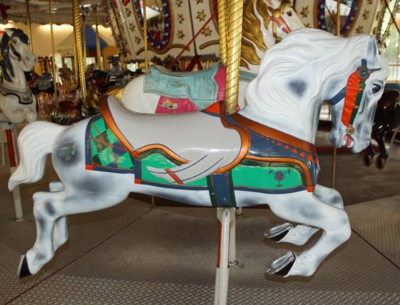 A white horse on a merry go round

Description automatically generated