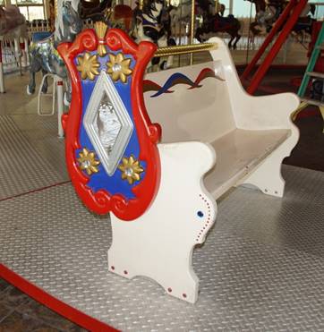 A white bench with a red and blue design

Description automatically generated