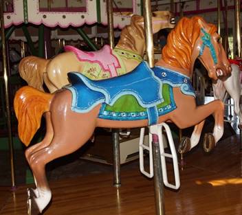 A person sitting on a chair in front of a carousel

Description generated with high confidence