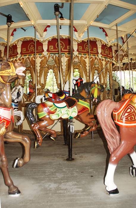 A picture containing carousel, object, ride, standing

Description automatically generated
