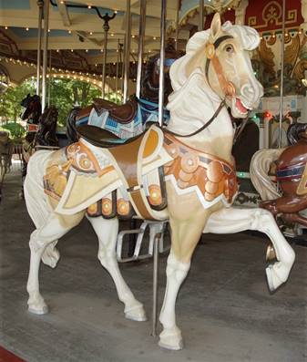 A cow standing on top of a carousel

Description automatically generated